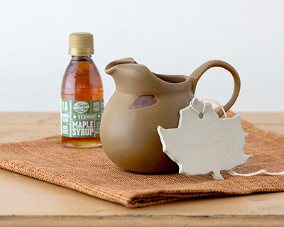 Vermont Greetings Pitcher with syrup and ornament in Tavernware glaze