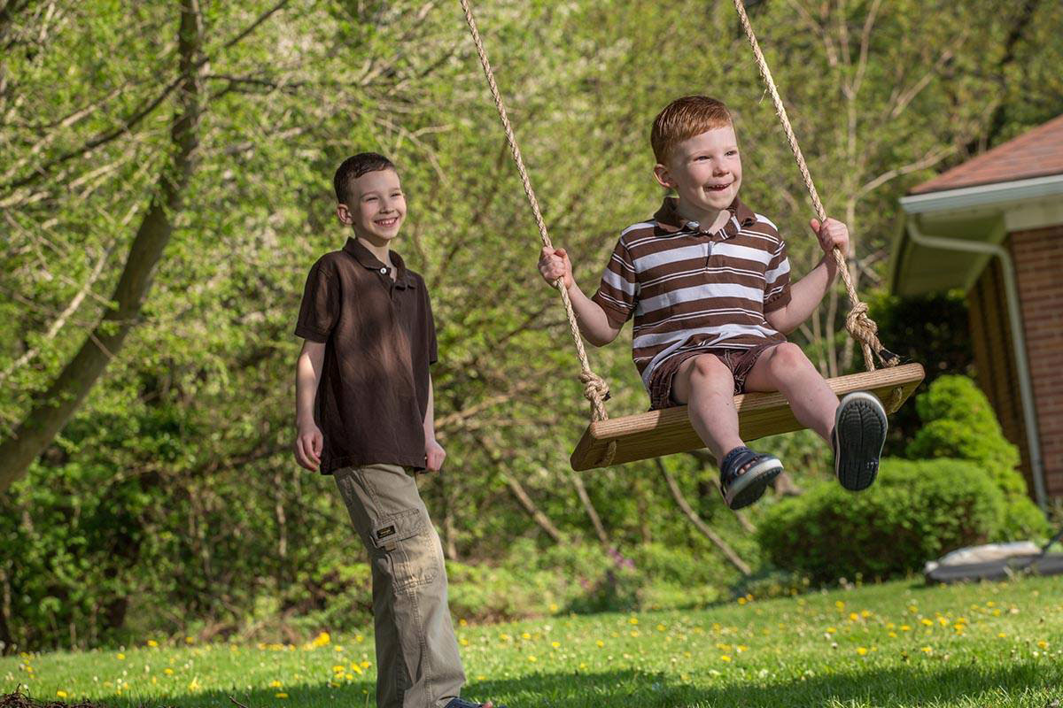 Picture of an employee's boys on a swing