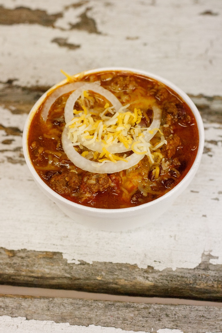 Hearty chili, smothered in cheese and onions